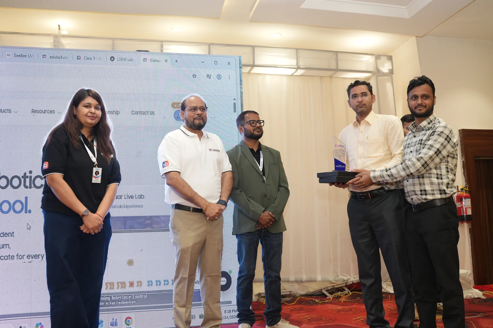 School principal receiving recognition memento from Edubull leadership