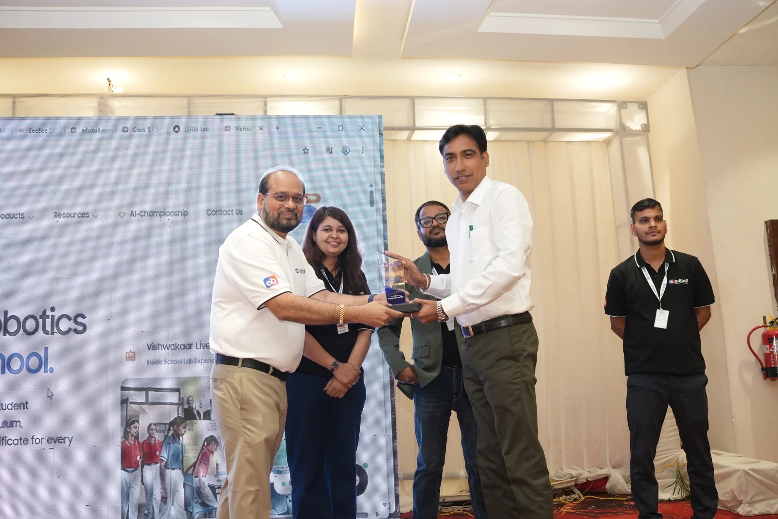 Principal receiving recognition trophy and certificate of partnership