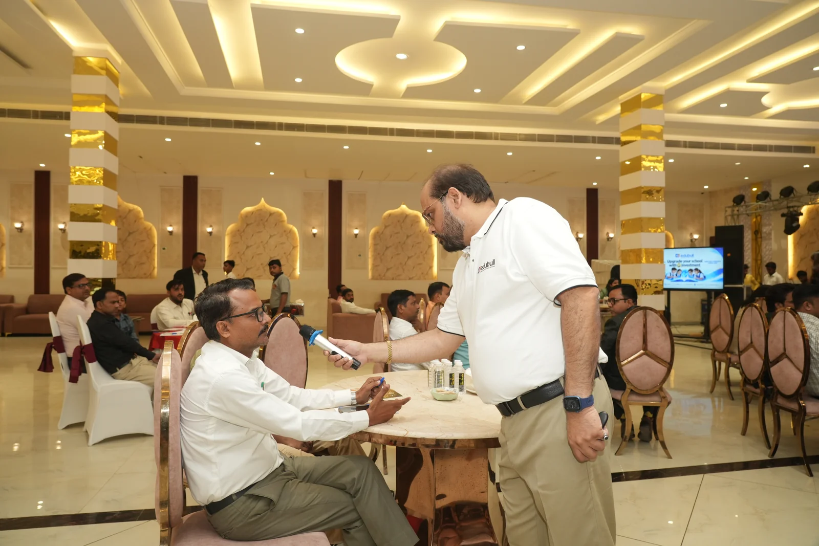 Mr. Girish Sharma engaging in mic dialogue with school principal at round table
