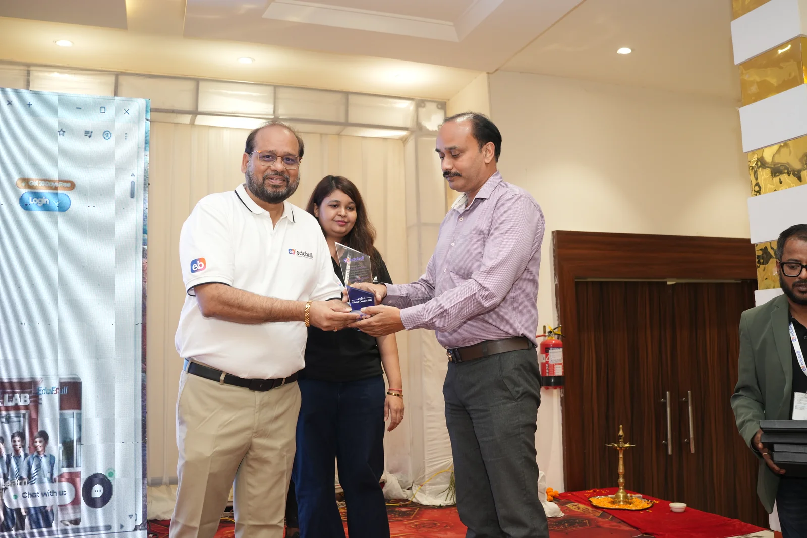 School head felicitated on stage during the conclave ceremony