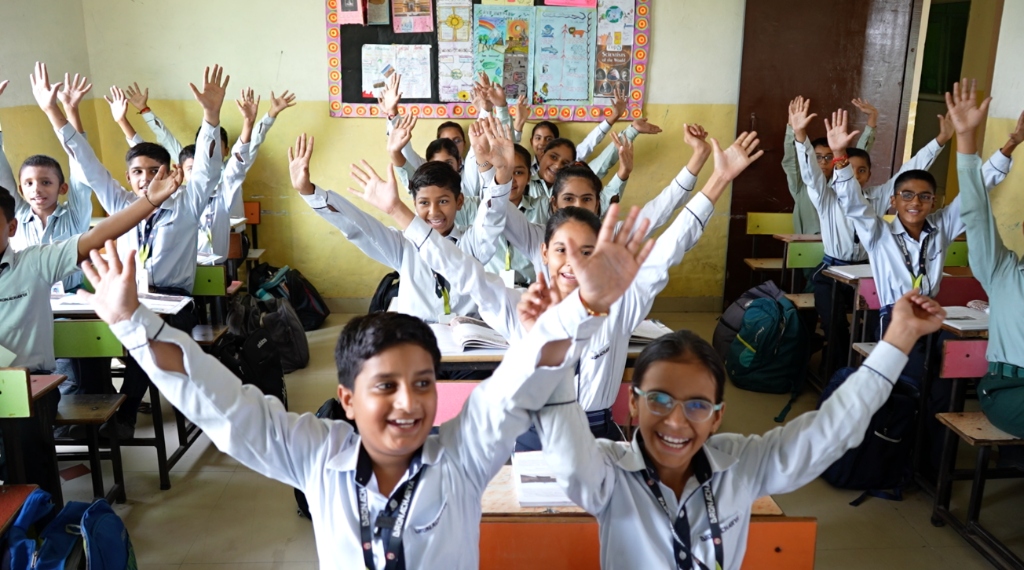 Happy students raising hands enthusiastically in an AI-enabled classroom
